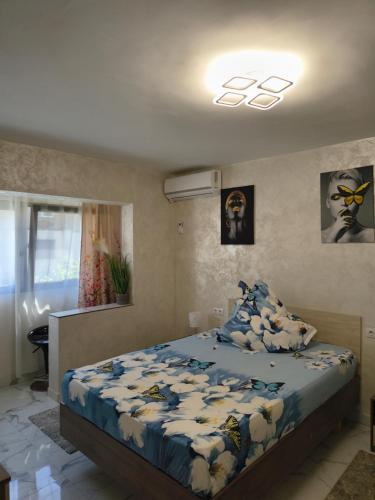 a bedroom with a bed with a comforter and pillows at Apartament TIMEEA Baile Herculane in Băile Herculane