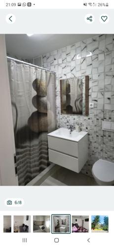 a bathroom with a sink and a toilet and a shower at Apartament TIMEEA Baile Herculane in Băile Herculane