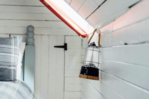 a lantern hanging on a wall in a bedroom at The Croft Collective in Oban