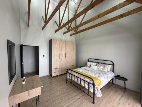 a bedroom with a bed and a wooden floor at Golden Treasure - OFF GRID in eMalahleni