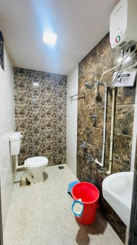 a bathroom with a toilet and a sink and a shower at NS Dosti By Glitz Cottage in Agashi