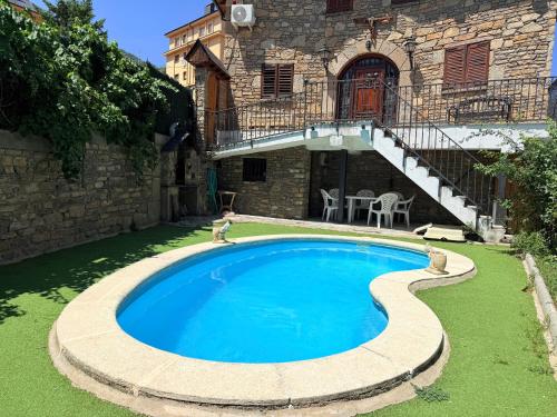 a swimming pool in the yard of a house at Can Florido - L'Amfitriona in Sort