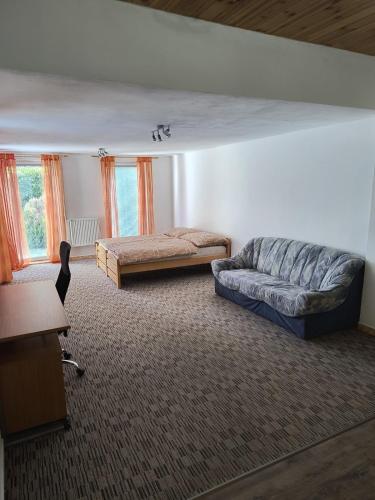 a living room with a couch and a bed at Volšovy Apartment in Sušice