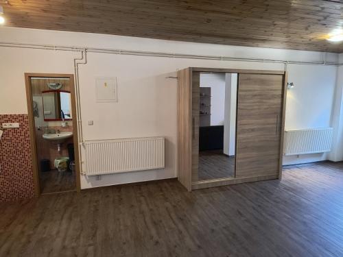 an empty room with a mirror and a sink at Volšovy Apartment in Sušice