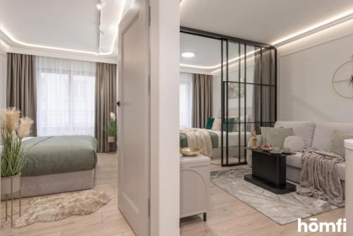 a bedroom with a bed and a living room at Libra Luxury AC - homfi Collection in Krakow