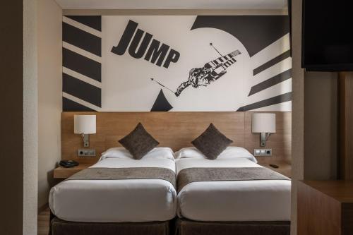 Ein Schlafzimmer mit einem großen Bett und einem Sprungschild an der Wand in der Unterkunft Estival Sporting in Pas de la Casa