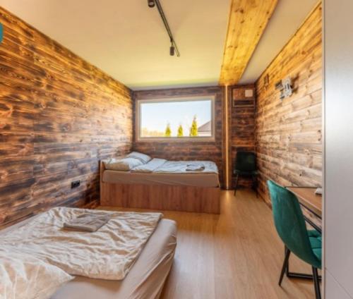 two beds in a room with a brick wall at Apartament Glamour II Kleszczów in Łękińsko