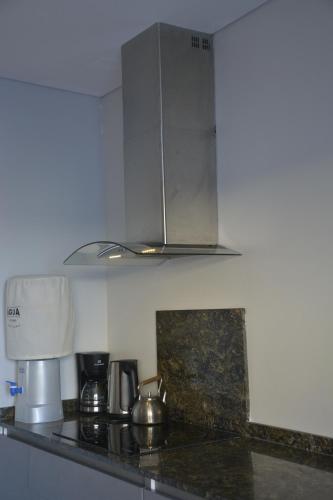 a kitchen with a counter top with a microwave at La ola in Puerto Pirámides