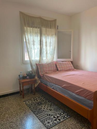 a bedroom with a large bed and a window at Appartement in Girona