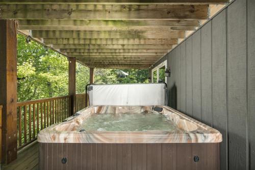 a hot tub on the deck of a house at Majestic Mountain Haus in Beech Mountain