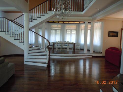 a living room with a staircase and a dining room at Moratuwa suburban oasis in Moratuwa