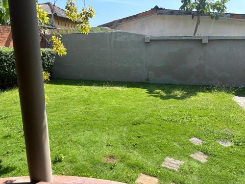 a yard with a fence and green grass at Moratuwa suburban oasis in Moratuwa