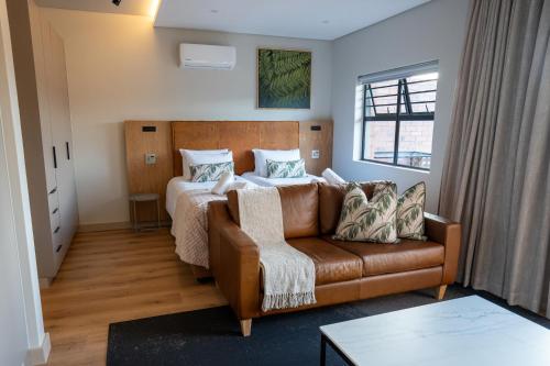 a living room with a couch and a bed at The Circle Luxury Self Catering Studios in Potchefstroom