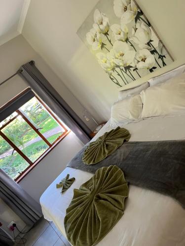 a bedroom with a bed with white flowers on it at Merwenstein - Farm House, Cottages, Studio-Units in Bonnievale