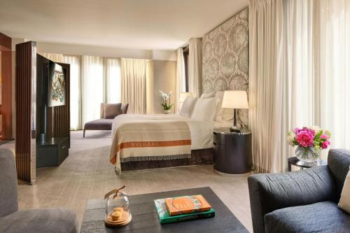 a hotel room with a bed and a living room at Bvlgari Hotel London in London