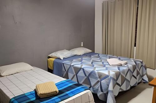 a room with two beds in a room at Sossego Real: Casa Solo C/ Banheira Ofuro in Ilhabela