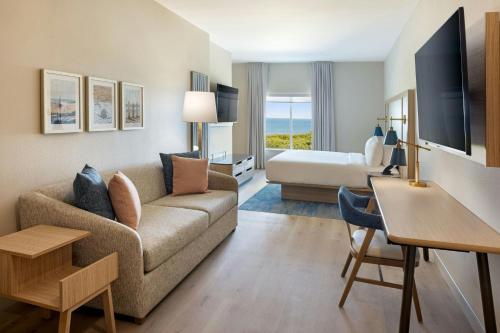 a living room with a couch and a bed at Fairfield Inn & Suites by Marriott Melbourne Beach in Melbourne