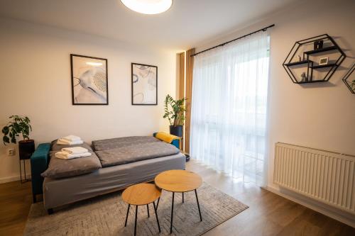 a bedroom with a bed and two tables at JM Apartment in Poprad