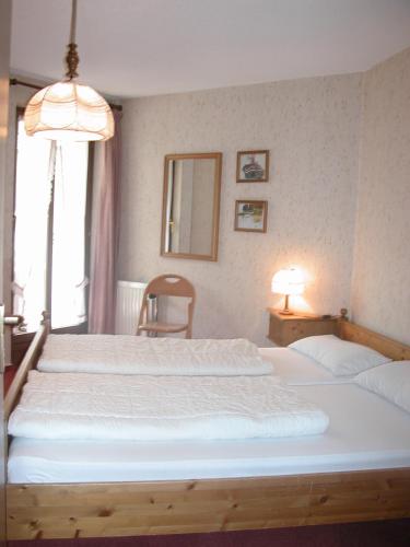 a bedroom with two beds and a large window at Ferienwohnungen Kupferkanne in Todtmoos