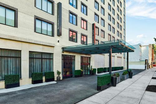 a building with a shelter in front of it at SpringHill Suites by Marriott New York Queens in Queens