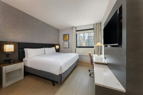 a hotel room with a bed and a television at Four Points by Sheraton Manhattan Midtown West in New York