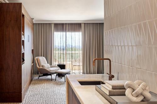 a bathroom with a sink and a living room at JW Marriott Phoenix Desert Ridge Resort & Spa in Phoenix