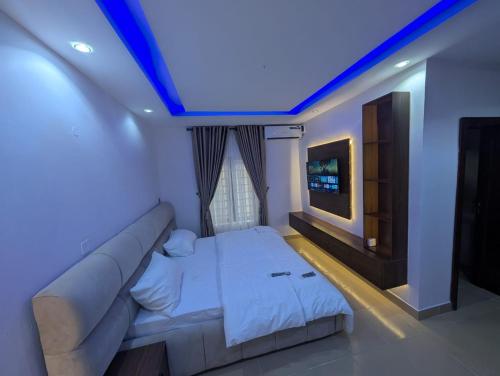 a living room with a couch and a tv at Kroft Residence in Lekki
