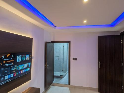 a living room with a blue led ceiling at Kroft Residence in Lekki