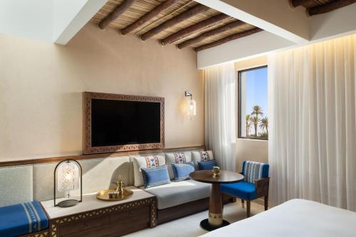 a hotel room with a couch and a tv at Bab Samhan, a Luxury Collection Hotel, Diriyah in Riyadh