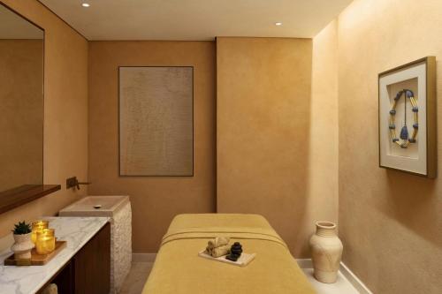 a small bathroom with a bed and a sink at Bab Samhan, a Luxury Collection Hotel, Diriyah in Riyadh