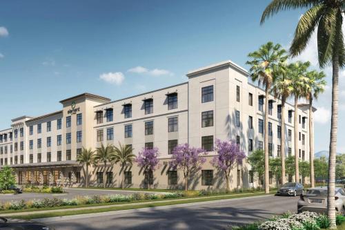 a rendering of a white building with palm trees and purple flowers at Element by Marriott San Diego Chula Vista in Chula Vista