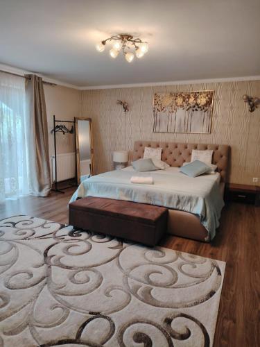 a bedroom with a large bed with a large rug at Casa Aura in Hunedoara