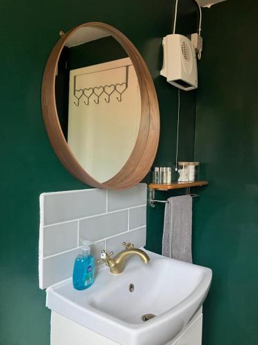 a bathroom with a sink and a mirror at Vintage Retreat in Kingussie