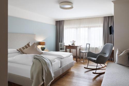 a bedroom with a bed and a desk and a chair at Landhaus Steiner in Altenmarkt im Pongau