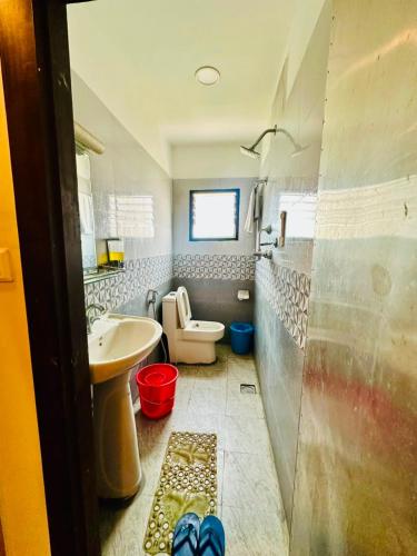 a small bathroom with a toilet and a sink at Hotel Attic Empire in Kathmandu