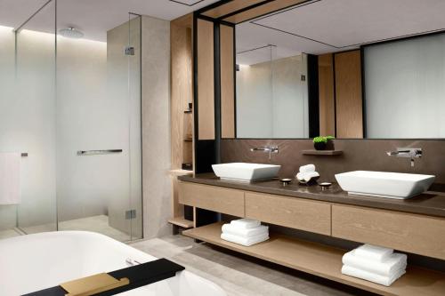 a bathroom with two sinks and a large mirror at The Ritz-Carlton, Suzhou in Suzhou