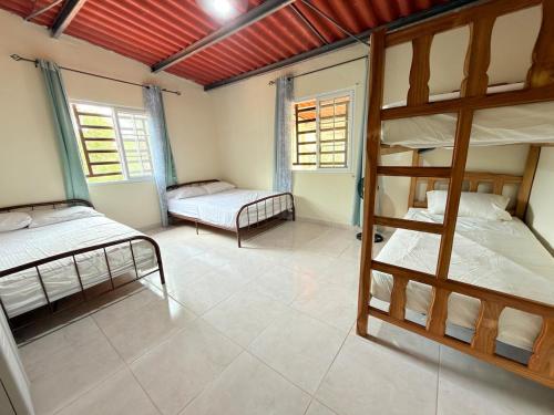 a room with two bunk beds and two windows at Rustic House in Cerro azul in Cerro Azul