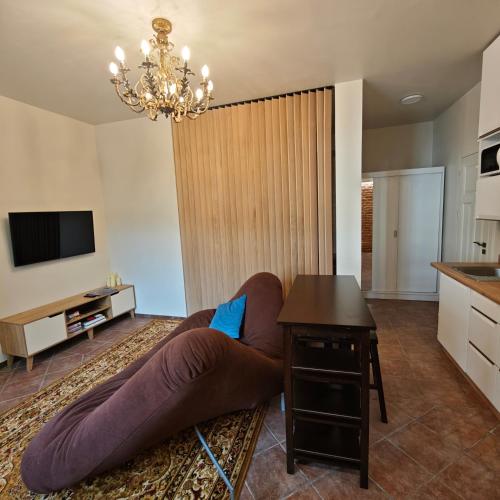 a living room with a couch and a table at Old town boutique apartaments in Ukmergė