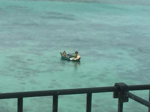 two people in a small boat in the water at Luxury Loft on the Sea in Trapani