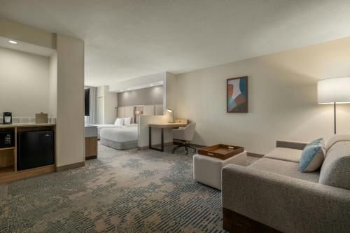 a hotel room with a bed and a living room at SpringHill Suites by Marriott - Tampa Brandon in Tampa
