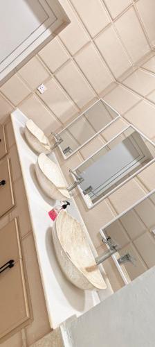 a row of sinks on a counter in a bathroom at فلل فاخرة للإيجار صلالة Salalah Villas in Salalah