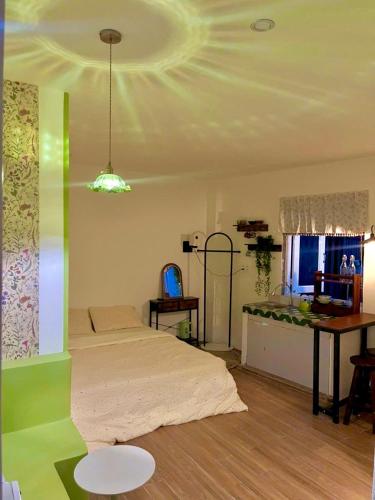 a bedroom with a bed and a table and a desk at The Miá home in Can Tho