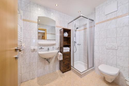 a bathroom with a sink and a shower and a toilet at Appartement Lea in Niederthai