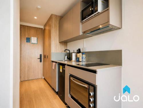 a kitchen with a sink and a counter top at Well 100 by JALO in Bogotá