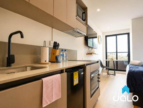 a kitchen with a sink and a counter top at Well 100 by JALO in Bogotá