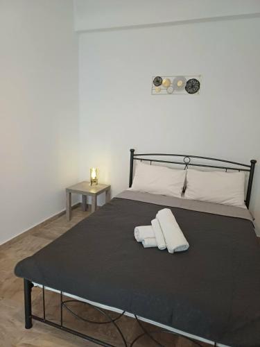 a bedroom with a bed with two towels on it at Cozy Corner Heraklion in Thérissos