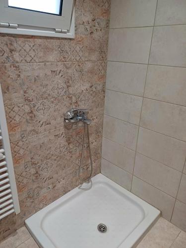 a bathroom with a shower with a white sink at Cozy Corner Heraklion in Thérissos