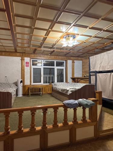 a large room with two beds and a balcony at Ho5tel House in Shymkent