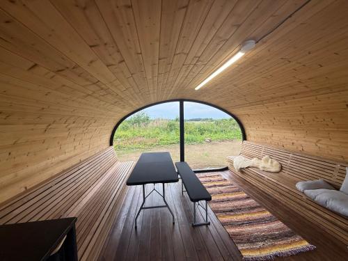 a room with a table and two chairs and a window at Log Off Männivälja forest cabins in Odulemma