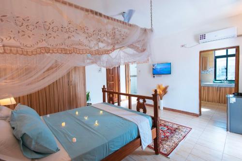 a bedroom with a bed with a canopy at Dianiluxe Villa - Spacious studio 4 in Galu